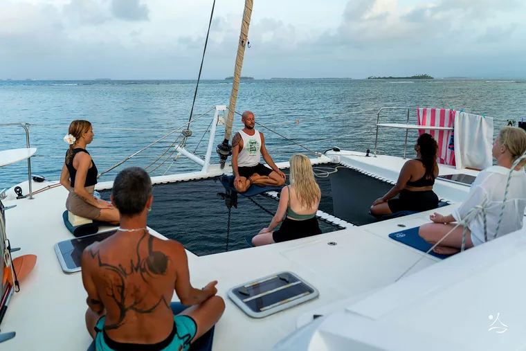 Meditation on the catamaran trampoline at sunset, in the San Blas islands.